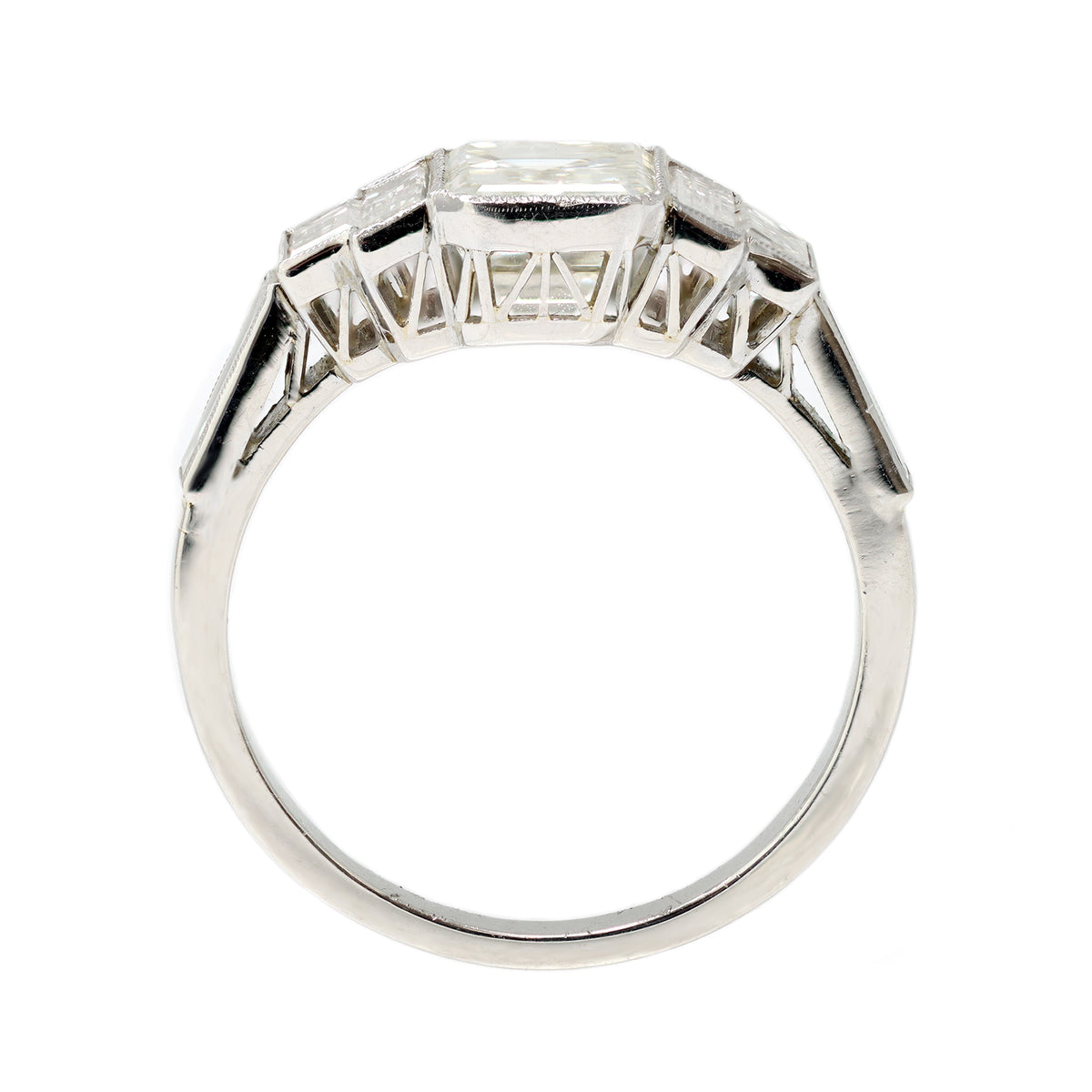 An Elegant Emerald-cut Diamond Ring with side baguettes set in Platinum front view