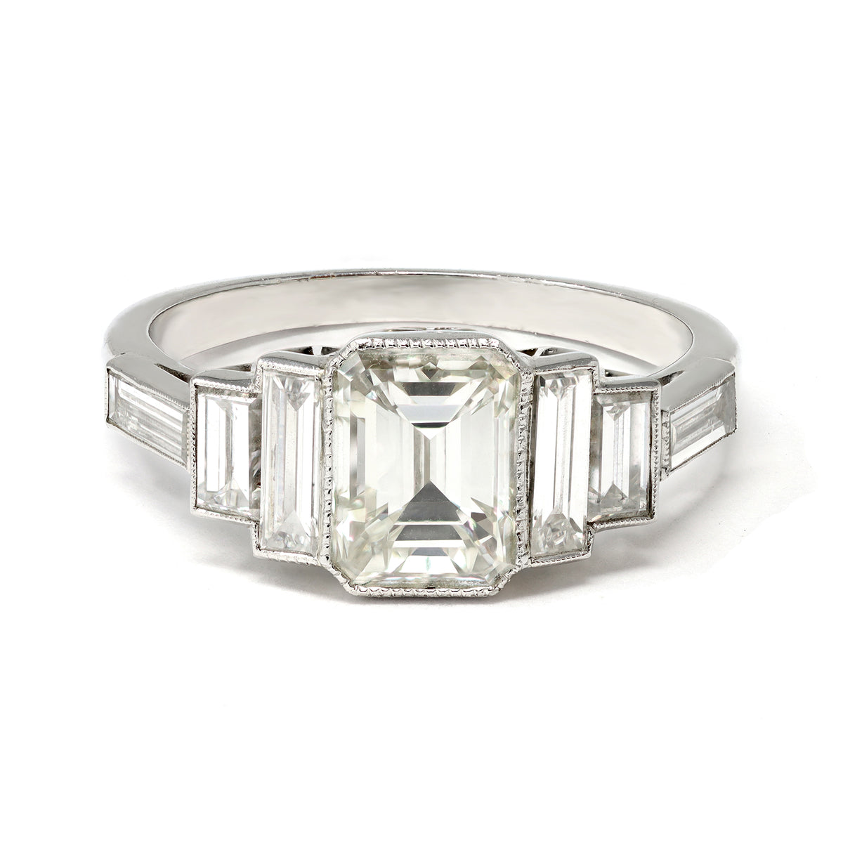 An Elegant Emerald-cut Diamond Ring with side baguettes set in Platinum top view