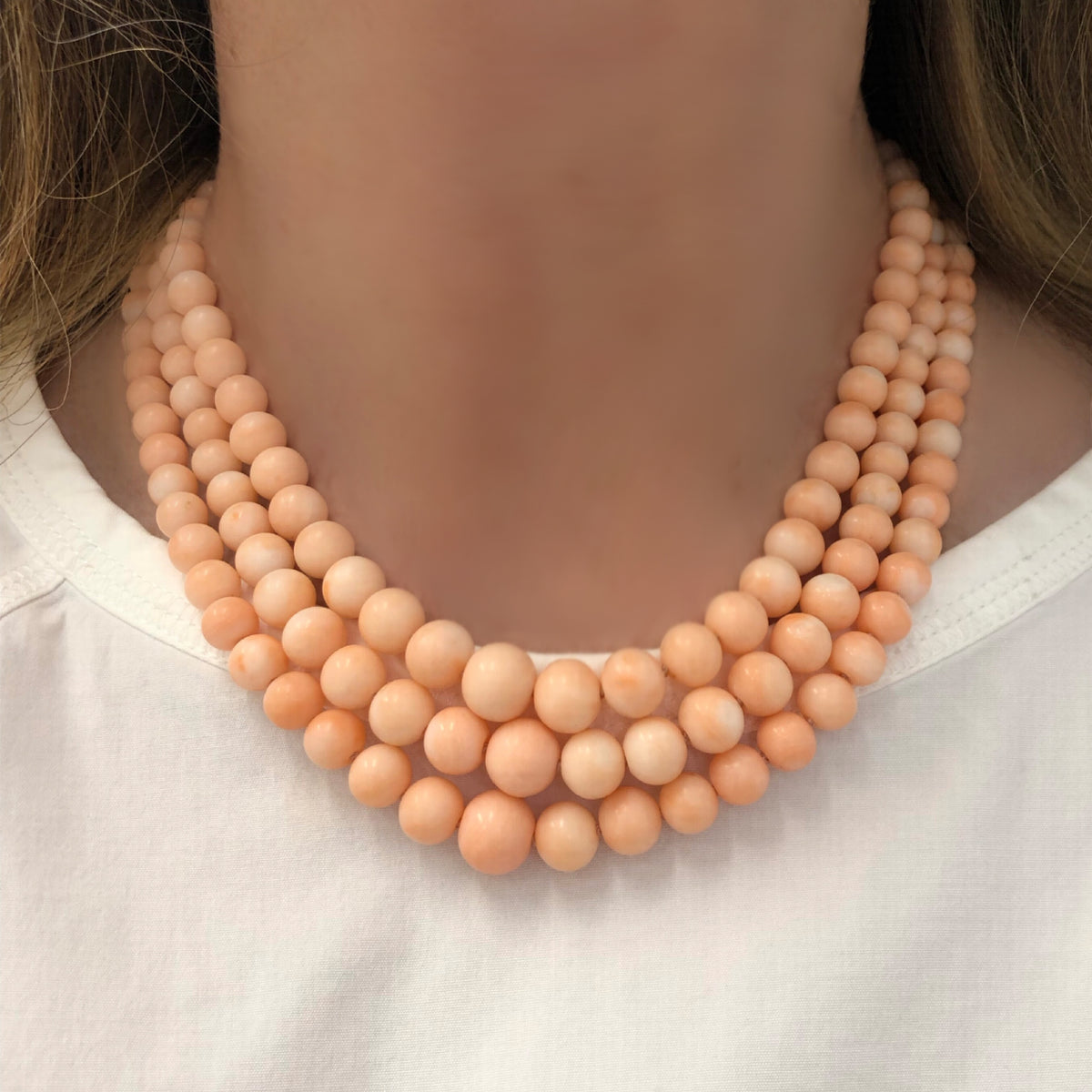 antique-1960s-angel-skin-coral-triple-strand-necklace-with-14-karat-yellow-gold-and-shell-clasp-model-view-2000x2000